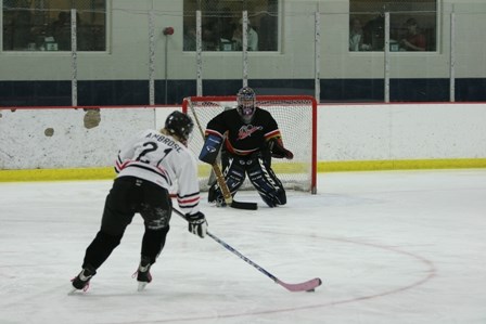 Female hockey player approaching goal